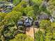 An aerial shot captures a charming home nestled among lush trees, showcasing its serene and private setting at 1350 Elizabeth Sw Ave, Atlanta, GA 30310