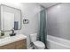 Bright bathroom with a bathtub shower, modern fixtures, and soft blue accents at 1350 Elizabeth Sw Ave, Atlanta, GA 30310
