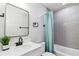 This bright bathroom features a shower over tub, stylish tiling, and a modern sink and vanity at 1350 Elizabeth Sw Ave, Atlanta, GA 30310