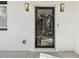 Close-up of the modern glass front door with stylish sconces and a clean, white brick facade at 1350 Elizabeth Sw Ave, Atlanta, GA 30310