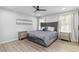 The main bedroom includes a large upholstered bed, stylish nightstands, and bright, light-filled windows at 1350 Elizabeth Sw Ave, Atlanta, GA 30310
