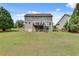 Expansive backyard features lush lawn, mature trees, deck and walkout basement, perfect for outdoor enjoyment at 179 Bradshaw Park Dr, Woodstock, GA 30188