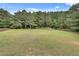 Secluded backyard area surrounded by mature trees, offering a serene and private outdoor space at 179 Bradshaw Park Dr, Woodstock, GA 30188
