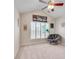 Comfortable bedroom with vaulted ceiling, ceiling fan, plantation shutters and cozy seating area at 179 Bradshaw Park Dr, Woodstock, GA 30188