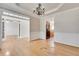 Elegant dining room with hardwood floors, decorative chandelier, and access to the kitchen at 179 Bradshaw Park Dr, Woodstock, GA 30188