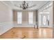 Refined dining room featuring hardwood floors, wainscoting, and a stylish chandelier at 179 Bradshaw Park Dr, Woodstock, GA 30188