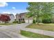 Attractive brick home with a lush front lawn, mature trees, and a convenient two-car garage at 179 Bradshaw Park Dr, Woodstock, GA 30188