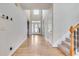 Bright foyer with hardwood floors and staircase, leading to the upper level of the home at 179 Bradshaw Park Dr, Woodstock, GA 30188
