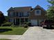 Charming two-story brick home with well-manicured lawn and a two-car garage at 179 Bradshaw Park Dr, Woodstock, GA 30188