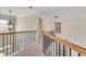 Upstairs hallway with natural light, decorative railings, and carpet flooring at 179 Bradshaw Park Dr, Woodstock, GA 30188