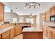 Kitchen with island, countertops, stainless appliances overlooking the fireplace at 179 Bradshaw Park Dr, Woodstock, GA 30188