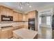 Kitchen with stainless steel appliances, island and view into the living room at 179 Bradshaw Park Dr, Woodstock, GA 30188