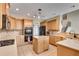 Well-lit kitchen featuring an island, stainless steel appliances, and tiled floors at 179 Bradshaw Park Dr, Woodstock, GA 30188