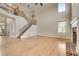 Spacious living room with high ceilings, fireplace, wood floors, and an elegant staircase at 179 Bradshaw Park Dr, Woodstock, GA 30188