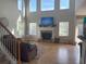 Spacious living area with tall windows, a fireplace, and hardwood floors at 179 Bradshaw Park Dr, Woodstock, GA 30188