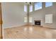 Bright living room boasts a fireplace, tall ceilings, and abundant natural light from multiple windows at 179 Bradshaw Park Dr, Woodstock, GA 30188