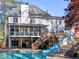 Exterior backyard showcasing a pool, screened porch, slide, and patio at 3012 Asheton Ne Pl, Marietta, GA 30068