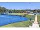Baseball field with lush green grass and a blue fence, set in a wooded area, designed for sports and recreation at 3012 Asheton Ne Pl, Marietta, GA 30068