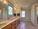 Lovely primary bathroom featuring long double sink vanity with framed mirror at 3012 Asheton Ne Pl, Marietta, GA 30068