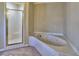 Bathroom featuring a white jacuzzi tub and glass enclosed shower at 3012 Asheton Ne Pl, Marietta, GA 30068