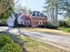 A beautiful two-story home features a brick facade, dark shutters, and a well-manicured front lawn at 3012 Asheton Ne Pl, Marietta, GA 30068