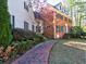 A charming brick home with black shutters and lush landscaping, creating an inviting curb appeal at 3012 Asheton Ne Pl, Marietta, GA 30068