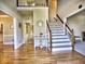 A bright and inviting foyer features hardwood floors, a staircase, and an open floor plan at 3012 Asheton Ne Pl, Marietta, GA 30068