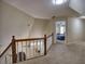 Upstairs hallway features a wooden railing and neutral carpet, leading to a bedroom at 3012 Asheton Ne Pl, Marietta, GA 30068