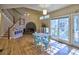 Great room with fireplace, staircase, and adjacent dining area with windows at 3012 Asheton Ne Pl, Marietta, GA 30068