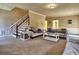 Spacious living room with plush sofas, wainscoting, and a staircase at 3012 Asheton Ne Pl, Marietta, GA 30068