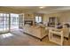 Spacious living room features a fireplace, plush carpets, and access to the screened porch at 3012 Asheton Ne Pl, Marietta, GA 30068