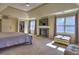 Bright main bedroom boasts a fireplace, TV, walk-in closet, and sun-filled windows at 3012 Asheton Ne Pl, Marietta, GA 30068
