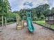 Community playground with slide, climbing features and benches, set in a natural, wooded environment at 3012 Asheton Ne Pl, Marietta, GA 30068