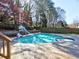 Backyard pool features a slide, spa, and surrounding mature trees creating a private oasis at 3012 Asheton Ne Pl, Marietta, GA 30068