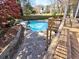Backyard pool features a slide, spa, and surrounding mature trees creating a private oasis at 3012 Asheton Ne Pl, Marietta, GA 30068