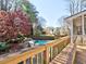 Backyard oasis featuring a sparkling swimming pool with slide, surrounded by lush landscaping and mature trees at 3012 Asheton Ne Pl, Marietta, GA 30068