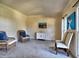 Sitting room with neutral carpet, windows, and a small accent cabinet with decorations at 3012 Asheton Ne Pl, Marietta, GA 30068