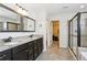 Bathroom boasts a granite countertop with dual sinks and a glass-enclosed shower with a walk-in closet at 3774 Thackary Dr, Powder Springs, GA 30127