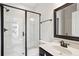 Modern bathroom featuring glass shower, a vanity with a framed mirror, and sleek black hardware at 3774 Thackary Dr, Powder Springs, GA 30127