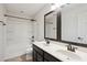 Bathroom with double vanity, framed mirrors, and a tub/shower combination at 3774 Thackary Dr, Powder Springs, GA 30127