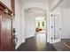 Bright foyer with dark wood floors, decorative moldings, and an arched doorway to the living room at 3774 Thackary Dr, Powder Springs, GA 30127