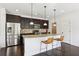 Modern kitchen with stainless steel appliances, granite countertops, an island with barstool seating, and dark wood floors at 3774 Thackary Dr, Powder Springs, GA 30127