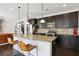 Spacious kitchen with granite countertops, stainless steel appliances and dark wood cabinets at 3774 Thackary Dr, Powder Springs, GA 30127