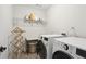Functional laundry room with front loading washer and dryer, storage shelf, and folding area at 3774 Thackary Dr, Powder Springs, GA 30127