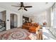 Open-concept living room with a comfortable sectional sofa and views of the modern kitchen and dining area at 3774 Thackary Dr, Powder Springs, GA 30127