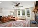Bright living room with a stone fireplace, large windows, and views of the kitchen and dining area at 3774 Thackary Dr, Powder Springs, GA 30127