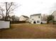 Spacious backyard with a patio, surrounded by a wood fence and adjacent homes, perfect for outdoor enjoyment at 102 Silver Fox Trl, Dallas, GA 30157