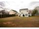 Backyard with grass and tall wooden fence surrounding property at 102 Silver Fox Trl, Dallas, GA 30157