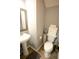 Cozy powder room with pedestal sink, modern fixtures, and wood-look flooring at 102 Silver Fox Trl, Dallas, GA 30157