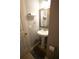 Small half-bathroom featuring a pedestal sink and neutral decor at 102 Silver Fox Trl, Dallas, GA 30157